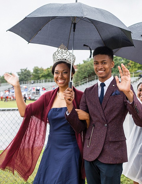 Miss VUU LaRae Gilliard and Mr. VUU Alphonso Ross wave to the crowd as they make the rounds at the football game. 
