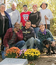Honoring the past //
When the headstone of a prominent Richmond physician born into slavery around 1852 was taken last year from historic East End Cemetery, his descendants and other volunteers raised money to purchase a new headstone.
The new marker for Dr. Richard F. Tancil was dedicated Oct. 22 during a short ceremony at the cemetery to honor the remarkable man who graduated from Howard University’s medical school and set up a practice in Church Hill. He also started the Nickel Savings Bank in 1896, and operated it out of his East End home.
Instrumental in replacing the grave marker are, standing from left, Dr. Tancil’s great-granddaughter-in-law, Susan Mitchell; John Shuck, coordinator of cleanup and restoration efforts at East End Cemetery; Jess Kilgore, Melissa Pocock and Bruce Tarr. Also, kneeling from left, Brian Palmer, Justin Curtis and Erin Palmer.
East End Cemetery, established around 1897, is the final resting place for more than 13,000 people, including pioneering educator and civic leader Rosa D. Bowser; Hezekiah F. Jonathan, vice president of Mechanics Savings Bank; and William Custalo, longtime proprietor of the Custalo House bar and restaurant on Broad Street.	 
