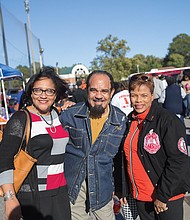 From left, Bobette Banks, Alfred Harris and Vicki Grant enjoy the food and fellowship at last Saturday’s homecoming tailgate.