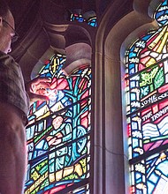 Andrew Goldkuhle of Goldkuhle Studios in Hanover County inspects and replaces stained glass images of the Confederate battle flag at Washington National Cathedral. The controversial flag was removed from two panes in August.