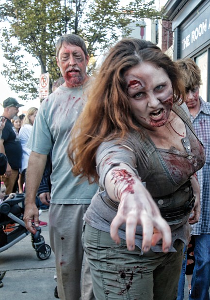 Zombies ‘attack’ Carytown //The sight of dozens of people dressed and made up to zombie perfection caused shoppers, restaurant- goers and spectators to pull out their cell phones, snap
photos and shoot videos.