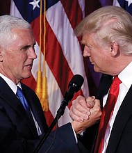 President-elect Donald Trump, right, thanks his vice presidential running mate, Gov. Mike Pence of Indiana, during their Election Night rally in New York that went into Wednesday morning. 
