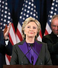 Democratic presidential candidate Hillary Clinton formally concedes to President-elect Donald Trump during a late-morning speech Wednesday to her staff and supporters at the Javits Convention Center in New York. Her husband, former President Bill Clinton, left, and her running mate, U.S. Sen. Tim Kaine of Virginia, applaud. 