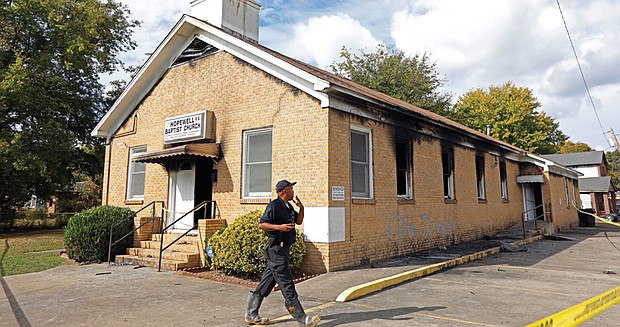 A fire marshal investigates damage at Hopewell Missionary Baptist Church in Greenville, Miss., which was burned and vandalized in a Nov. 1 fire.