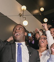Richmond Mayor-elect Levar Stoney cheers in victory late Tuesday night at a Downtown restaurant while surrounded by campaign staff and supporters.