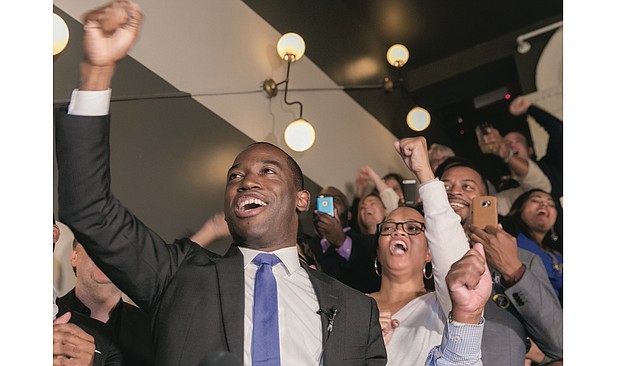 Richmond Mayor-elect Levar Stoney cheers in victory late Tuesday night at a Downtown restaurant while surrounded by campaign staff and supporters.