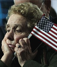 A Clinton supporter dejectedly listens as unfavorable election results are reported during an Election Night rally in New York.