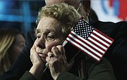 A Clinton supporter dejectedly listens as unfavorable election results are reported during an Election Night rally in New York.