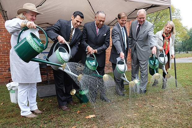 City park to get facelift // Monroe Park is about to become a construction site — bringing a temporary end to its role as a shade tree haven for college students and the homeless. 
Beginning next Monday, Nov. 14, the park is to be shut down and fenced off for at least a year and possibly as long as 18 months, according to the city, to make way for a $6 million facelift. 
A centerpiece of the city since 1851 and once used as state fairgrounds and a military encampment, the park has been targeted for major improvement for at least 12 years.    
The 8-acre park is bounded by Belvidere, Main, Laurel and Franklin streets.
Mayor Dwight C. Jones launched the long-awaited project Wednesday with representatives of Virginia Commonwealth University and the private Monroe Park Conservancy, which will manage the park after the work is done. 
The city will be investing about half the money, mostly to dig up and replace the aging underground water, sewer, natural gas and electrical lines that serve VCU, The Fan and other neighborhoods in the Near West End. 
The conservancy, a private group led by Alice McGuire Massie, has raised $3 million since 2013 to pay for additional improvements, ranging from new plantings and new walkways to improved lighting and creation of a tiny stream for racing small boats. 
Other additions are to include movable tables and chairs, a game area for playing a ring-toss game called quoits and a lawn bowling game called pétanque, the conservancy has said.  
The conservancy is seeking to raise an additional $1.5 million to redo the Checkers House in the park to provide public restrooms, space for a café and meetings along with a plaza for park visitors. 
Still, the park’s overhaul will mean upheaval for the homeless and advocates for the homeless who offer meals, clothing and services to the needy at the park. There has been no announcement of where feeding programs plan to move.


From left, Alice M. Massie, president of the Monroe Park Conservancy; Dr. Michael Rao, Virginia Commonwealth University president; Mayor Dwight C. Jones; Hunter Applewhite, president of the Dominion Foundation; Charlie Agee, Altria Group’s director of corporate contributions and community involvement; and Rossie C. Hutcheson, president of the Beirne Carter Foundation, ceremonially water the grass at Monroe Park to kick off a $6 million renovation of the centrally located park.