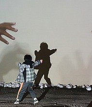 In the light //
A youngster interacts with Miatta Kawinzi’s art installation “Gatherin’ Place” during InLight Richmond 2016, an annual one-night, free outdoor exhibition of light-based art and performances organized by 1708 Gallery. This year’s event was held last Friday in Scott’s Addition, where people wandered among the creative array of lighted exhibits on walls, pathways, sidewalks and green spaces. Jellyfish-shaped lanterns were part of the event’s kickoff Community Lantern Parade.
