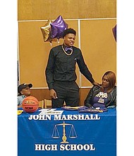 
John Marshall High School hoops standout Greg Jones makes his college choice official — James Madison University. His mother, Jennifer Mack, and brother, Diego Smith, were with him on signing day, Nov. 9, at the school library.