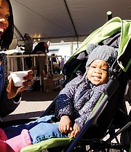 Soup’s on // Year-old Nevaeah Scott, above, has other interests rather than the stew offered by her mother, Deanna Scott, at the recent 2016 Brunswick Stew Festival.