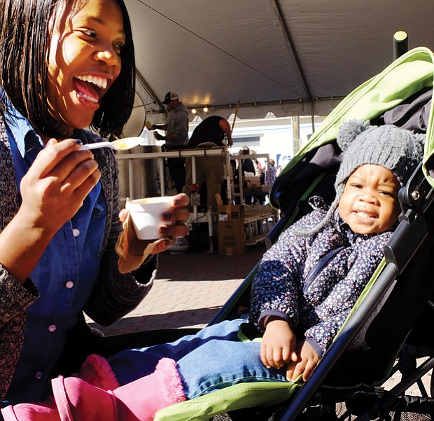 Soup’s on // Year-old Nevaeah Scott, above, has other interests rather than the stew offered by her mother, Deanna Scott, at the recent 2016 Brunswick Stew Festival.