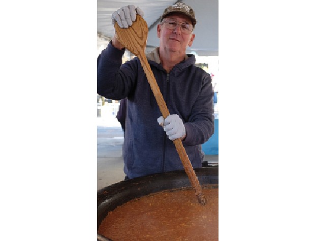 Soups on // The 17th Street Farmers’ Market in Shockoe Bottom became a wonderful kitchen on Nov. 5 as Meredith Minter of Highland Springs, left, and other cooks stirred and served enormous vats of brunswick stew. 