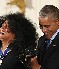 Entertainment icon Diana Ross shares a laugh with President Obama as he secures her Medal of Freedom during a ceremony before family and special guests at the White House. 
