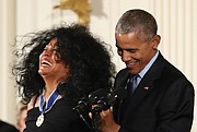 Entertainment icon Diana Ross shares a laugh with President Obama as he secures her Medal of Freedom during a ceremony before family and special guests at the White House. 
