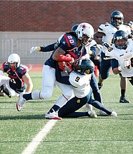University of Richmond running back Deontez Thompson is swamped by the North Carolina A&T State University defense last Saturday before being taken down by Aggies defensive back Zerius Lockhart, No. 9 jersey, in the NCAA playoff matchup at Robins Stadium. 