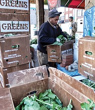 Timothy Christian sorts through a box of fresh leafy greens as he prepares for holiday shoppers at the 17th Street Farmers’ Market in Shockoe Bottom. Similar markets have sprouted in the Richmond area, but this market is the oldest. It has been a public gathering place since 1737, five years before Richmond was incorporated as a town. The site was designated as a “public market” in 1779, just a year before Richmond was officially named the state capital and three years before Richmond was designated an independent city. The city is to give the market area a facelift to create a more European-style plaza. 