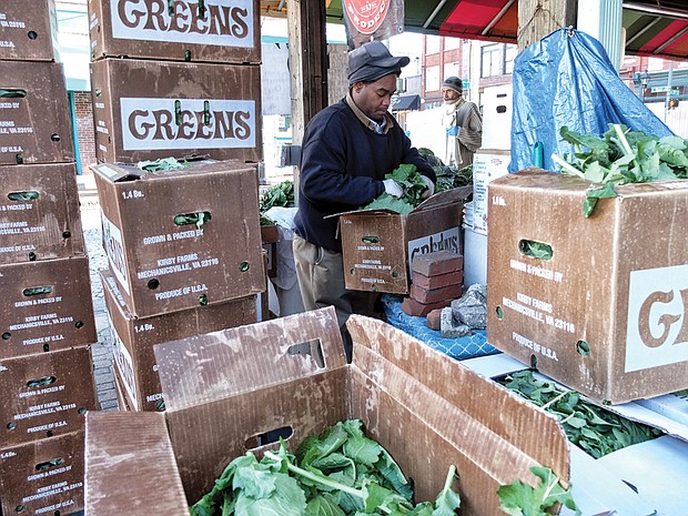 Timothy Christian sorts through a box of fresh leafy greens as he prepares for holiday shoppers at the 17th Street Farmers’ Market in Shockoe Bottom. Similar markets have sprouted in the Richmond area, but this market is the oldest. It has been a public gathering place since 1737, five years before Richmond was incorporated as a town. The site was designated as a “public market” in 1779, just a year before Richmond was officially named the state capital and three years before Richmond was designated an independent city. The city is to give the market area a facelift to create a more European-style plaza. 