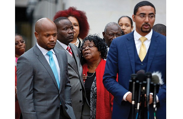 Judy Scott, center, is comforted by her son, Rodney Scott, as family attorneys Chris Stewart, left, and Justin Bamberg, right, hold a news conference Monday after a mistrial was declared in the case involving the shooting death of Mrs. Scott’s son, Walter Scott, last year in North Charleston, S.C. A videotape of the death shows Mr. Scott, 50, was shot in the back by former Patrolman Michael Slager. A mistrial was declared after the jury deadlocked. 