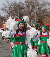 Cheery “elves” from Prestige Dance Studio in Midlothian wave to the crowd near the beginning of the parade route. 