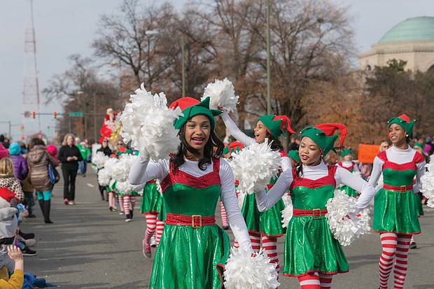 Cheery “elves” from Prestige Dance Studio in Midlothian wave to the crowd near the beginning of the parade route. 