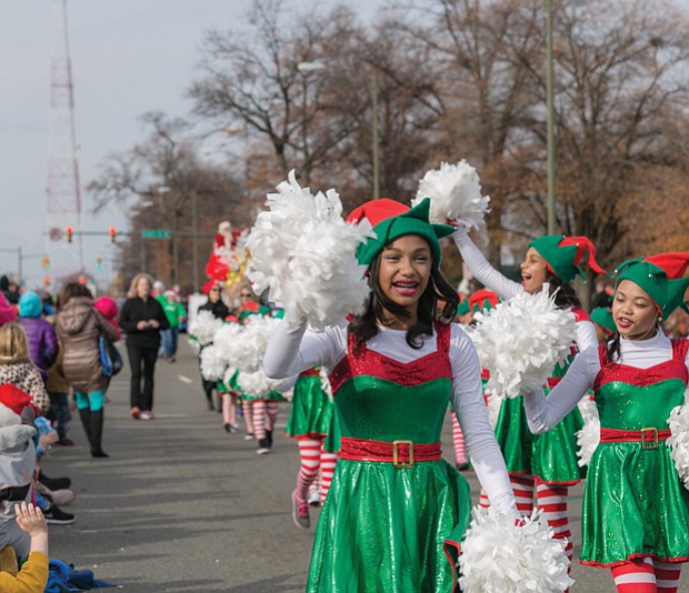 Cheery “elves” from Prestige Dance Studio in Midlothian wave to the crowd near the beginning of the parade route. 