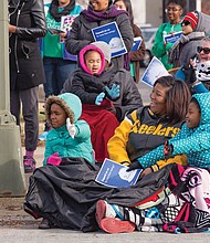 Floats and units in the Dominion Christmas Parade draw cheers from spectators bundled up along Broad Street on Saturday. 