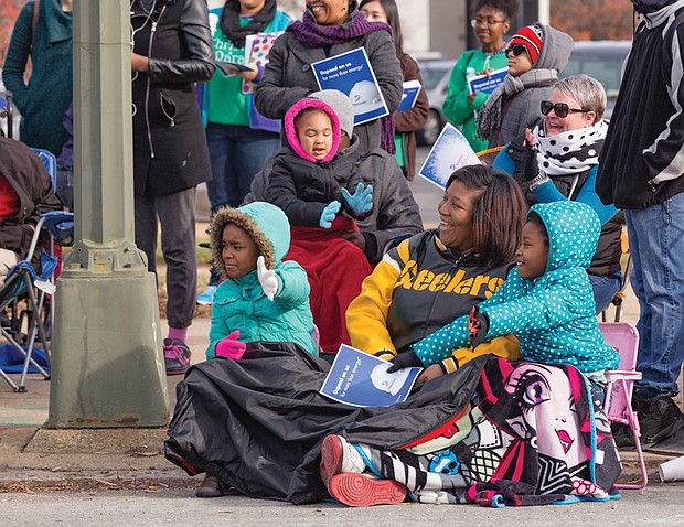 Floats and units in the Dominion Christmas Parade draw cheers from spectators bundled up along Broad Street on Saturday. 