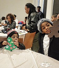 Quincey Grimes, 6, right, inspects the gingerbread man he decorated as his brother, Chase, 2, works on a Christmas tree. The two were making holiday ornaments for their father, Cedric Grimes. 
The museum, located at 122 W. Leigh St. in Jackson Ward, will host another holiday open house from noon to 4 p.m. Saturday, Dec. 10.