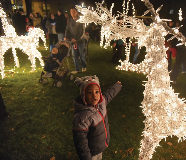 
Josiah Nicholas, 2, reaches out to touch a lighted reindeer during Friday’s Grand Illumination at the James Center. 