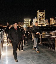 The first pedestrians stream across the newly opened T. Tyler Potterfield Memorial Bridge over the James River. Mayor Dwight C. Jones led the ribbon-cutting for the lighted bridge during the Grand Illumination on Friday. Richmond poured $11.3 million in state and city funds into the span open only to pedestrians and bikes. The new river crossing sits above a 1901 dam and links Brown’s Island on the North Side to an overlook on the South Side near the entry to the Manchester Bridge. Another $200,000 was spent on eight, 17-foot-tall metal rings that Denver artist Joshua Wiener created to adorn the South Side path to the 1,600-foot bridge. The bridge is named for a senior city planner who advocated for the bridge before his death in 2014.  Construction began in October 2015 on the only current city structure named for a city employee.  