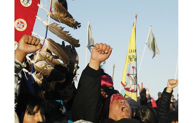 Native American “water protectors” celebrate last Sunday’s decision by the Army Corps of Engineers stopping the easement for the $3.8 billion Dakota Access pipeline next to the Standing Rock Sioux Reservation near Cannon Ball, N.D. 