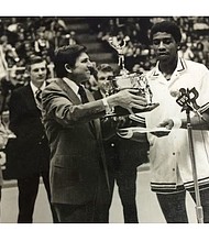 At the Aron Stewart Day ceremony in February 1974, the University of Richmond basketball star is presented with a trophy by UR President E. Bruce Heilman, while former Coach Mac Pitt, far left, applauds.