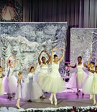 the Dance Candle Academy of Performing and Sacred Arts founder Karen Watkins Rios, center, performs a perfect relevé with her dancers during “Clara’s Christmas Gift” on Saturday. 