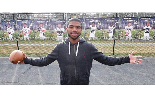 Senior Chris Thaxton, the Highland Springs High School wide receiver who scored the winning touchdown giving the Springers the state football title, stands Wednesday amid banners of the championship team members showcased outside the Henrico County school. Below, the football helmet worn by Thaxton is adorned with a purple ribbon, angel wings and the insignia “AngieStrong,” honoring his mother and team booster, Angela “Angie” Johnson.