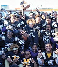 Highland Springs High School varsity football players celebrate their back-to-back Division 5 state football championship win on Dec. 10 at Hampton University. The Springers clinched the title for the second time, beating Stone Bridge High School of Loudoun County 35-29. 