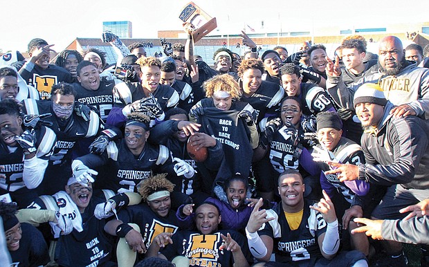 Highland Springs High School varsity football players celebrate their back-to-back Division 5 state football championship win on Dec. 10 at Hampton University. The Springers clinched the title for the second time, beating Stone Bridge High School of Loudoun County 35-29. 