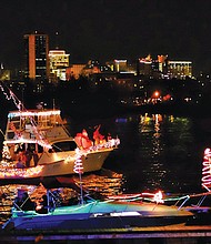 Parade of Lights // Festively decorated boats lighted up the James River and the Richmond skyline Saturday night during the 24th Annual Parade of Lights.
About 13 boats participated in the lighted holiday boat parade despite a devastating fire last Friday at the Richmond Yacht Basin that destroyed several boats that were slated to be part of the event. 