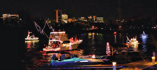 Parade of Lights // Festively decorated boats lighted up the James River and the Richmond skyline Saturday night during the 24th Annual Parade of Lights.
About 13 boats participated in the lighted holiday boat parade despite a devastating fire last Friday at the Richmond Yacht Basin that destroyed several boats that were slated to be part of the event. 