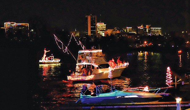 Parade of Lights // Festively decorated boats lighted up the James River and the Richmond skyline Saturday night during the 24th Annual Parade of Lights.
About 13 boats participated in the lighted holiday boat parade despite a devastating fire last Friday at the Richmond Yacht Basin that destroyed several boats that were slated to be part of the event. 