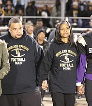 
Chris Thaxton, right, escorts his parents, Karlos and Angela “Angie” Johnson, center, and sister, Taylor, onto the field during the Springers’ Senior Night ceremony Nov. 4. Mrs. Johnson, a longtime athletic booster, succumbed to bladder cancer just days later on Nov. 12. She was 45. 