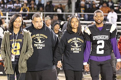 
Chris Thaxton, right, escorts his parents, Karlos and Angela “Angie” Johnson, center, and sister, Taylor, onto the field during the Springers’ Senior Night ceremony Nov. 4. Mrs. Johnson, a longtime athletic booster, succumbed to bladder cancer just days later on Nov. 12. She was 45. 