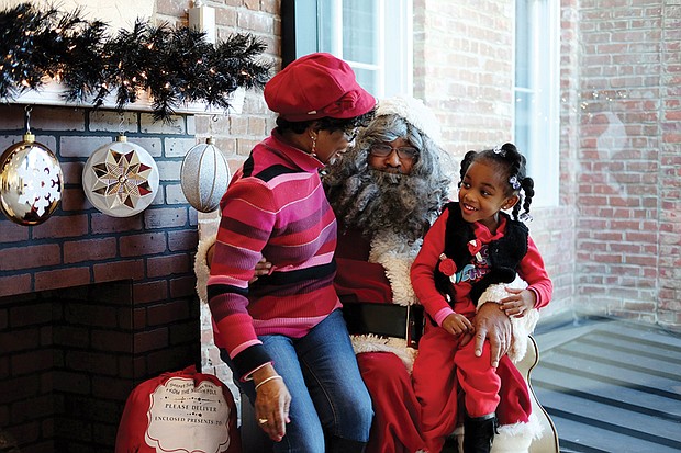 Sharing with Soul Santa //
Kennedi Ellis, 4, is shy about giving her wish list to Santa during a recent visit to the Black History Museum and Cultural Center of Virginia in Richmond’s Jackson Ward. The museum’s Soul Santa was a hit with the young — and the young at heart — during the museum’s annual holiday open house. Soul Santa made appearances on two consecutive weekends.