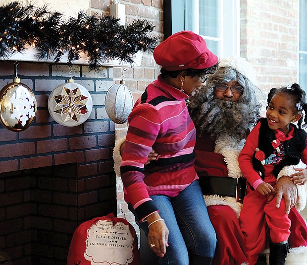 Sharing with Soul Santa //
Kennedi Ellis, 4, is shy about giving her wish list to Santa during a recent visit to the Black History Museum and Cultural Center of Virginia in Richmond’s Jackson Ward. The museum’s Soul Santa was a hit with the young — and the young at heart — during the museum’s annual holiday open house. Soul Santa made appearances on two consecutive weekends.