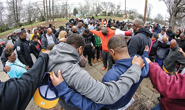 The group known as Coaches Against Violence Everywhere joined in a circle of prayer with community members in Creighton Court in January and spoke out against violence that has claimed the lives of young people in Metro Richmond.