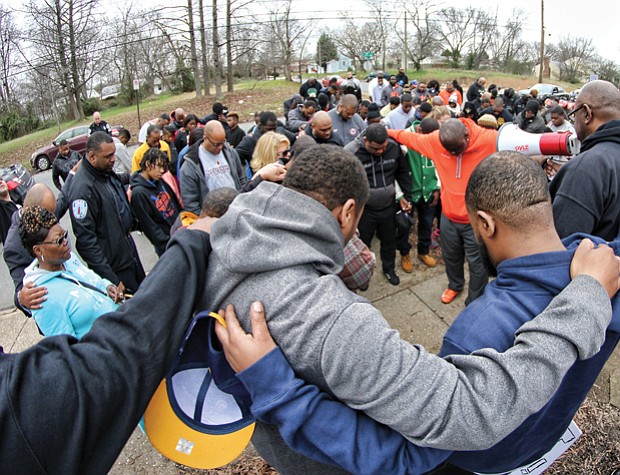 The group known as Coaches Against Violence Everywhere joined in a circle of prayer with community members in Creighton Court in January and spoke out against violence that has claimed the lives of young people in Metro Richmond.