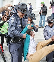 Capitol Police carry away a demonstrator who refused to leave the south steps of the Capitol during a February protest of utility giant Dominion’s plans to deal with coal ash. About eight people were arrested.