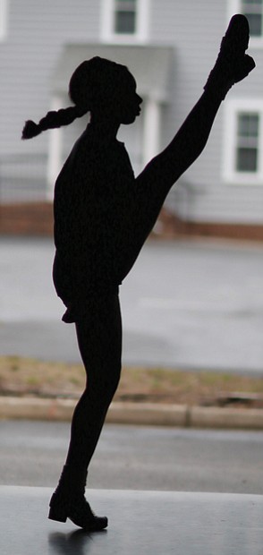 Morgan Bullock, seen in silhouette, practices one of the intricate and athletic Irish dance moves in April at the Baffa Academy of Irish Dance in Chesterfield County. The Richmond area teen placed 50th for her solo dancing in the World Irish Dance Championships.