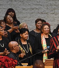 The Rev. Delores McQuinn, right, a member of the Virginia House of Delegates, sings with the choir during the service.
